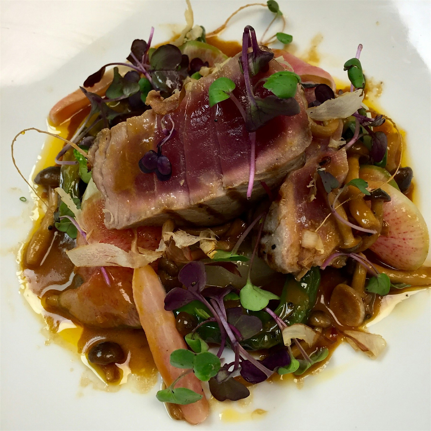 Tuna over batchoy, miso butter, and radishes 2 ways, garnished of with some bonito flakes. 