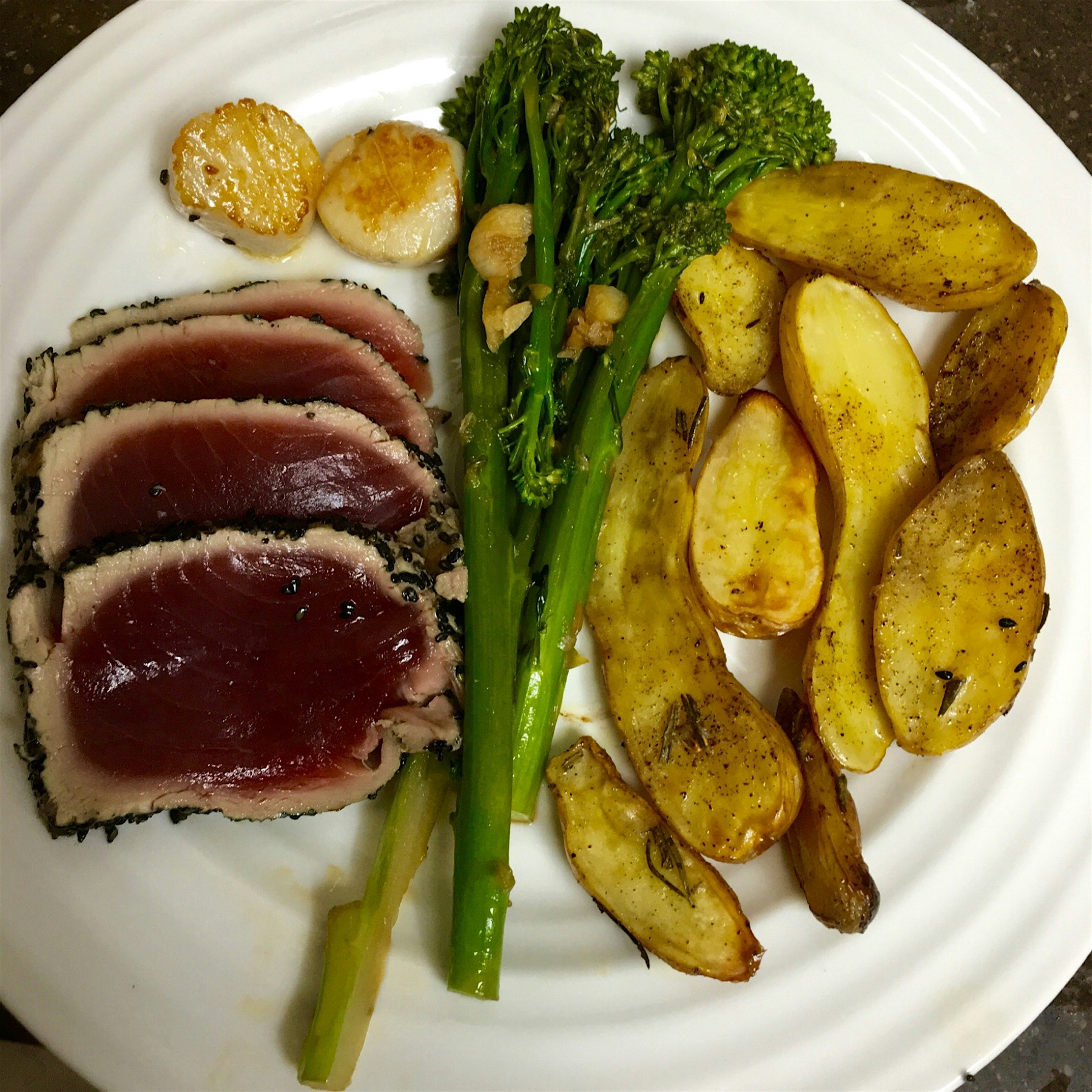 Special Sunday night family meal. Grilled Tuna coated with sesame seeds, broccolini with garlic, ...