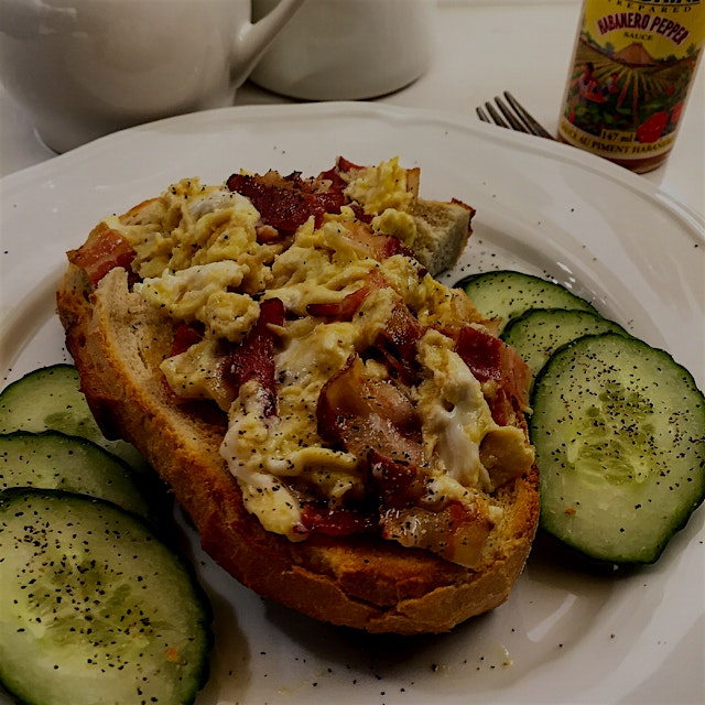 My happy place: creamy scrambled eggs (pet peeve: overdone eggs!) with bacon on sourdough. Choppi...