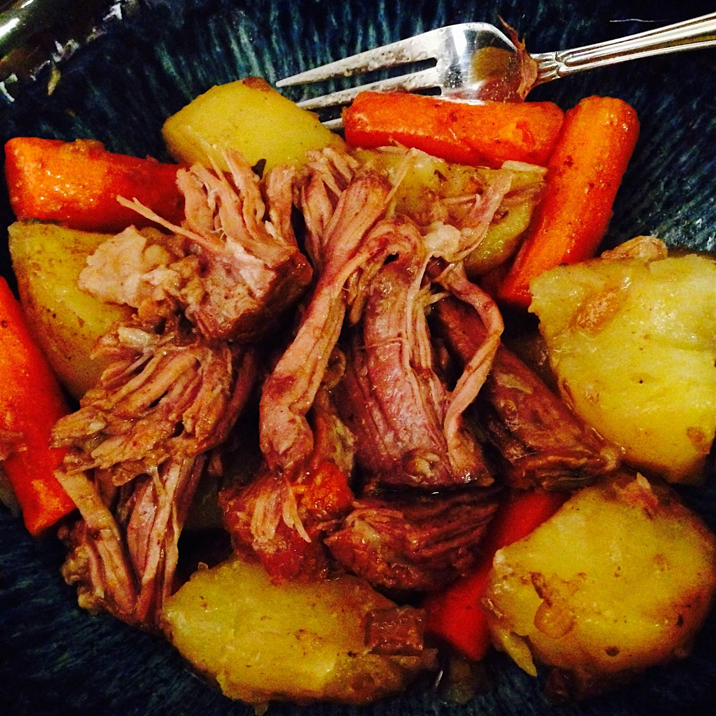 Beef pot roast with carrots and potatoes cooked in the crockpot. Super easy and delicious!