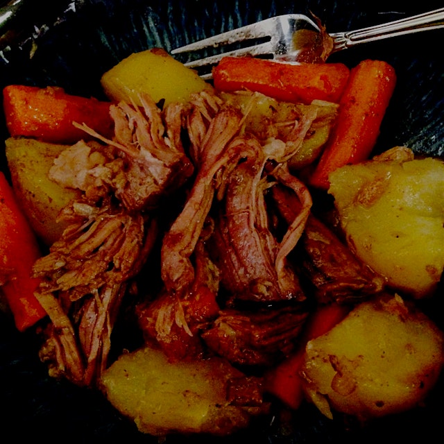 Beef pot roast with carrots and potatoes cooked in the crockpot. Super easy and delicious!