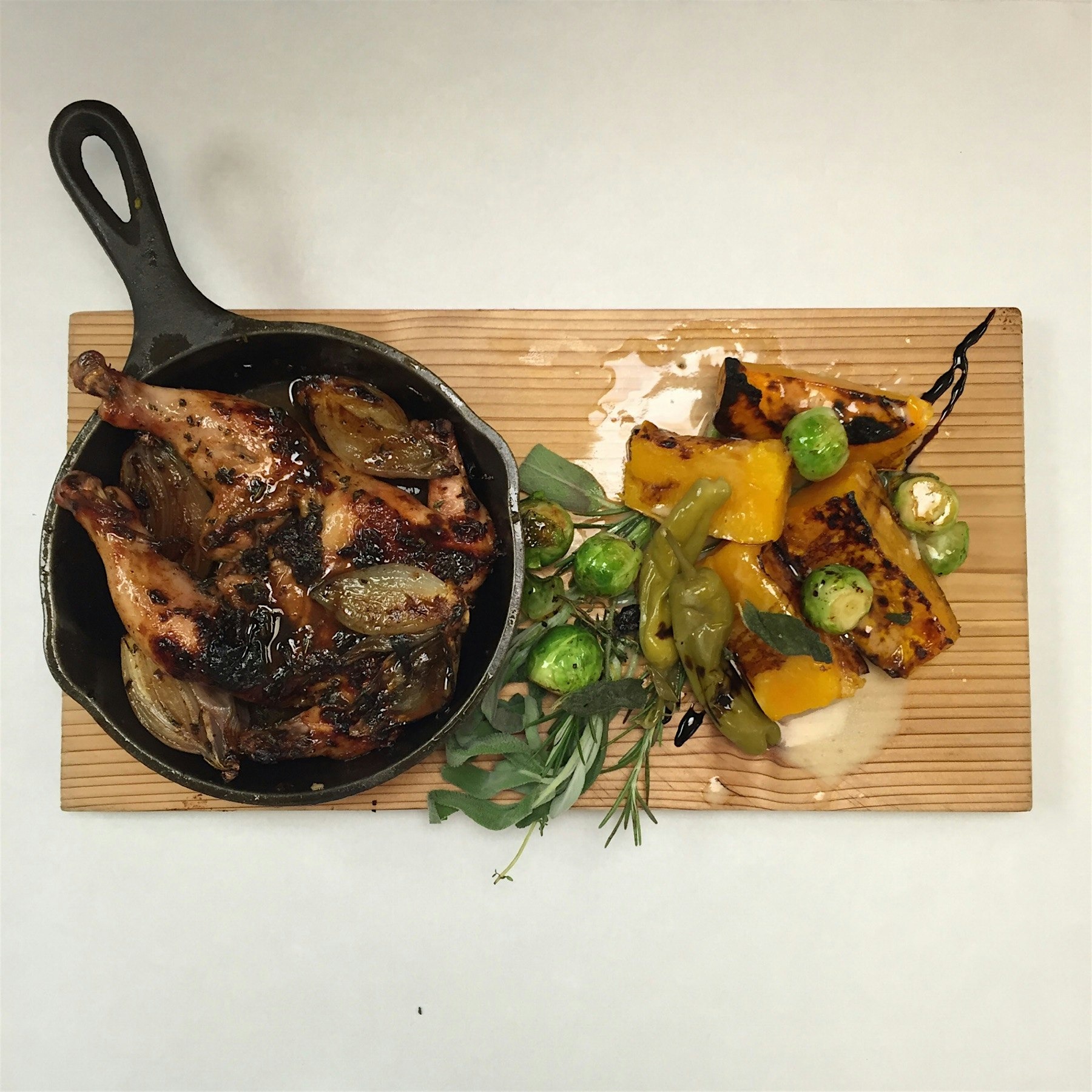Roasted Poussin, ancho chilly glaze, brussel sprouts, honey butternut squash, topped off with som...