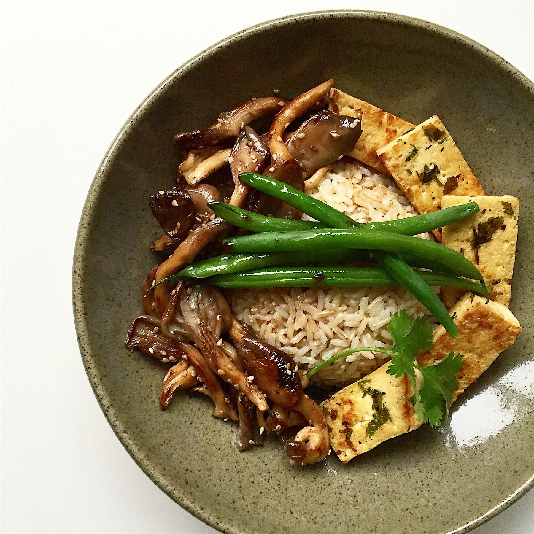 Brown rice bowl with Tamari honey glazed mushrooms, coriander marinated tofu and boiled green beans