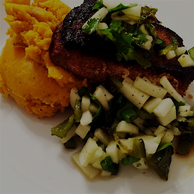 Spiced pork chop with poblano apple salsa and olive oil smashed sweet potatoes