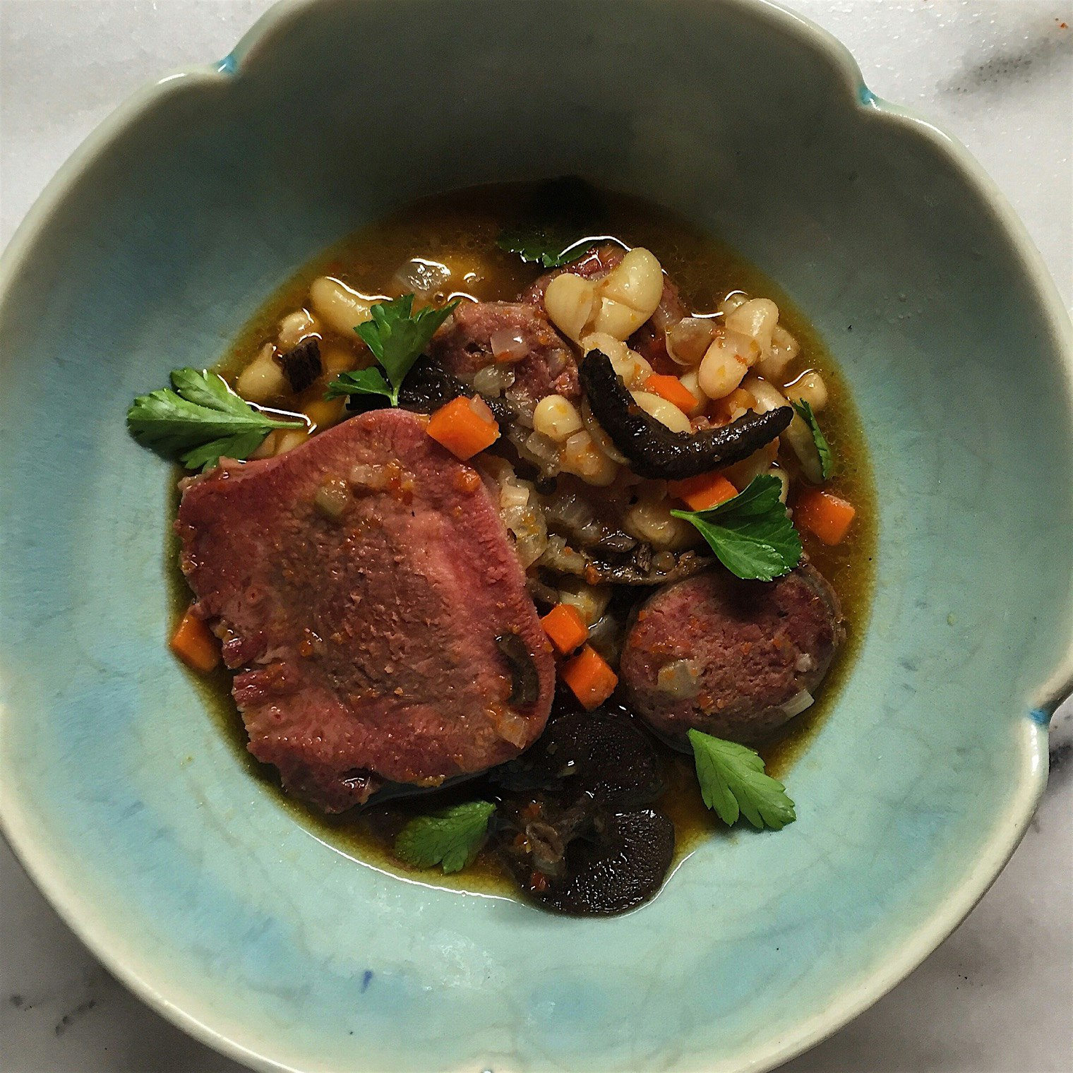Goose sausage, beef tongue, sullius americanus, beans, goose broth. 