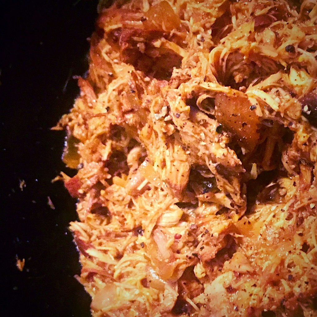 In my crockpot: Chicken Thighs, braised in Barbecue sauce with Garlic Cloves, Yellow Onion, Whole...