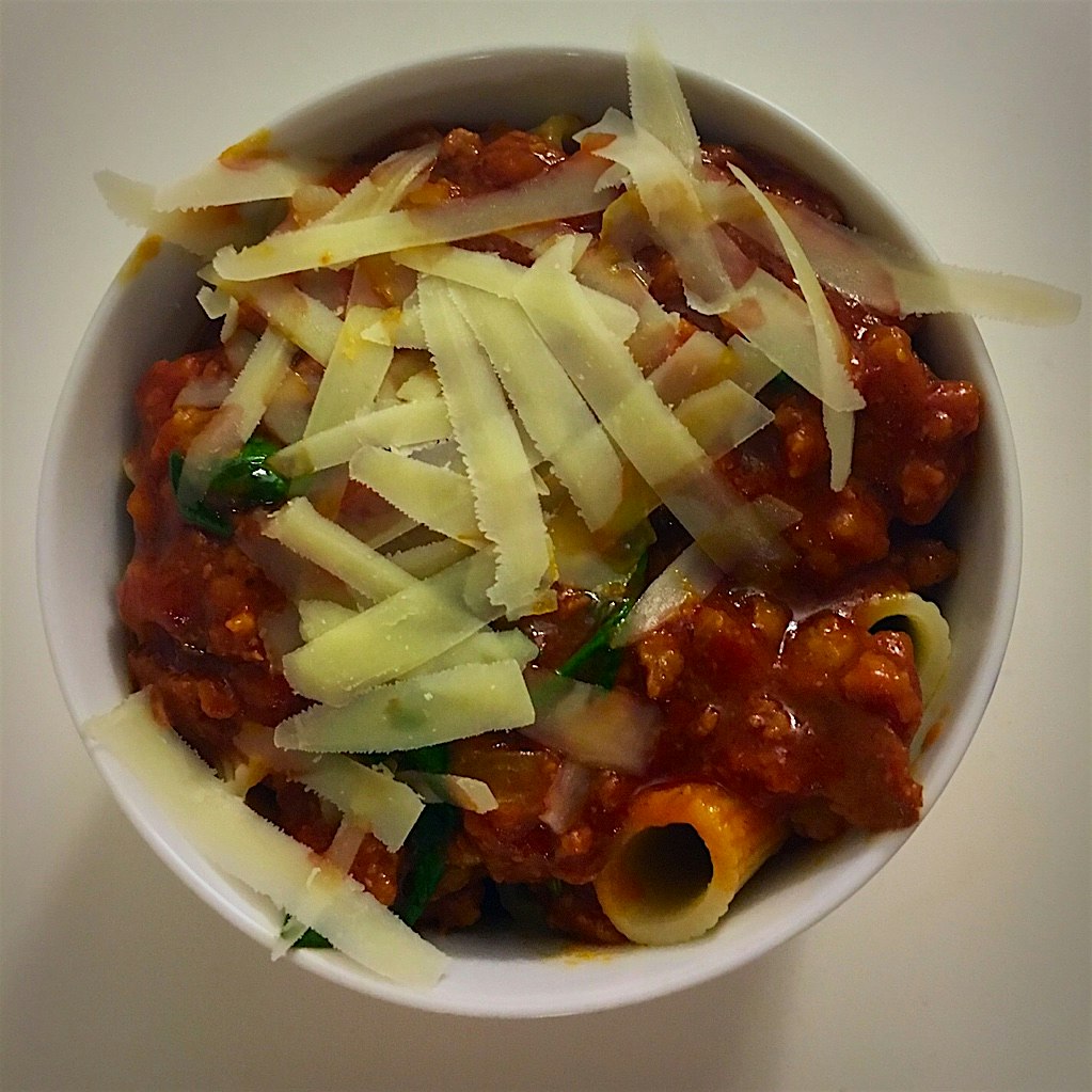 Hot Italian sausage bolognese with spinach and rigatoni topped wth Parmesan cheese! 