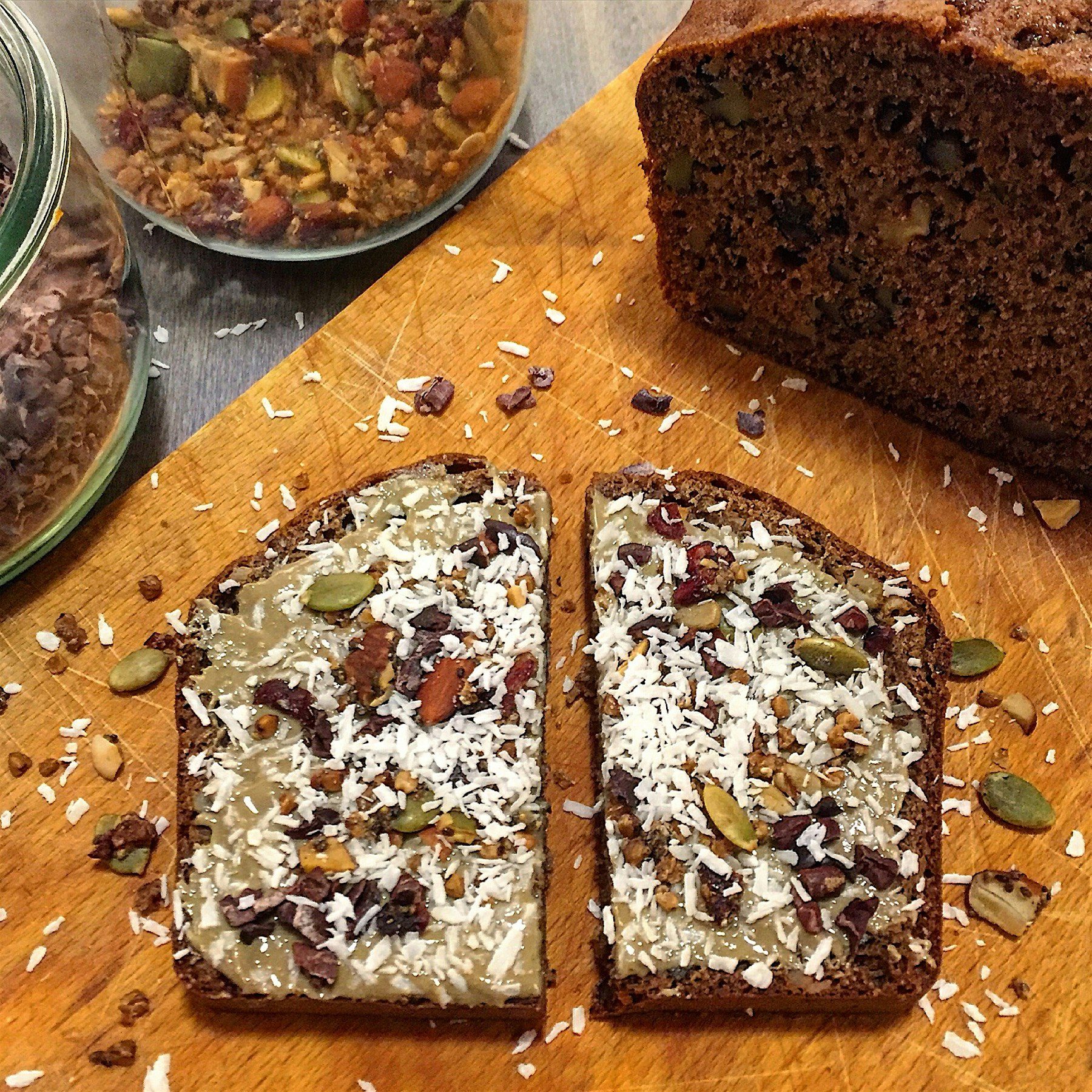 Toasted banana bread with sunflower seed butter, granola, and a flurry of coconut, because there ...