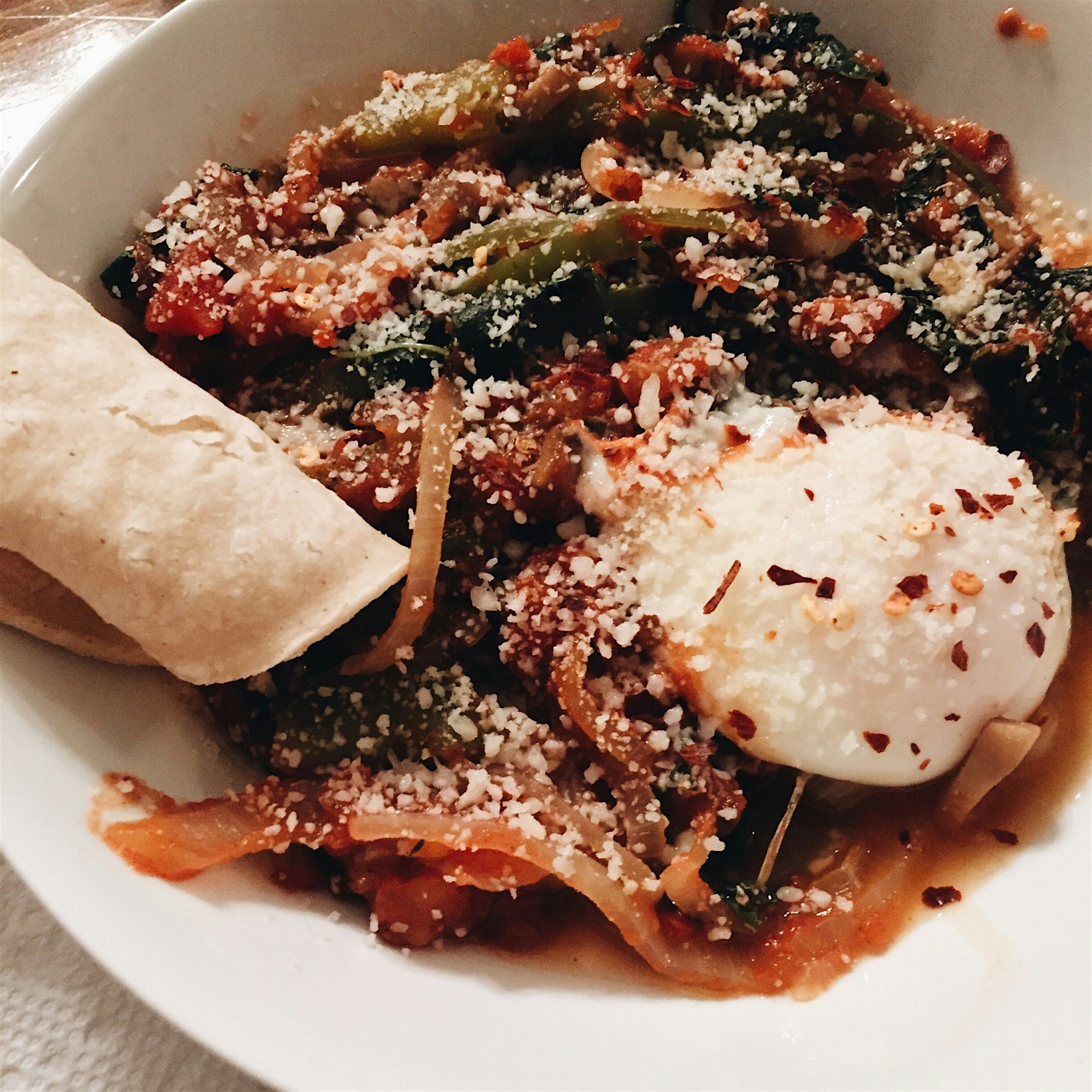 Cacciatore style baked eggs topped with Parmesan and served with corn tortilla (& toasted baguett...