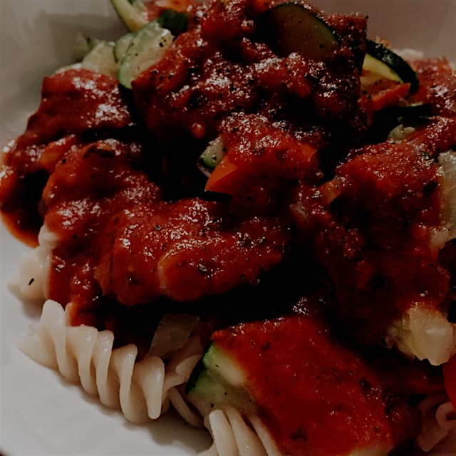 Chunky tomato sauce over zucchini, peppers and brown rice pasta