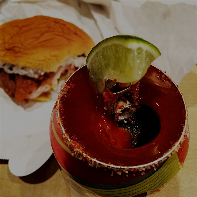 Washing down that spicy Chicken sandwich with a Michelada - a can of Tecate is topped with house ...