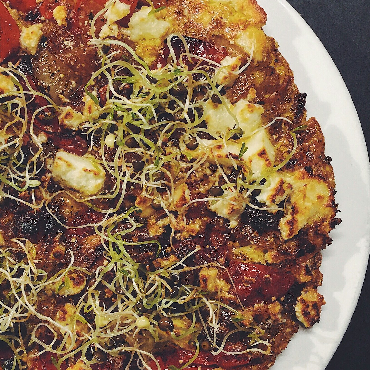 Egg pie with roasted peppers, queso fresco and lentil sprouts.