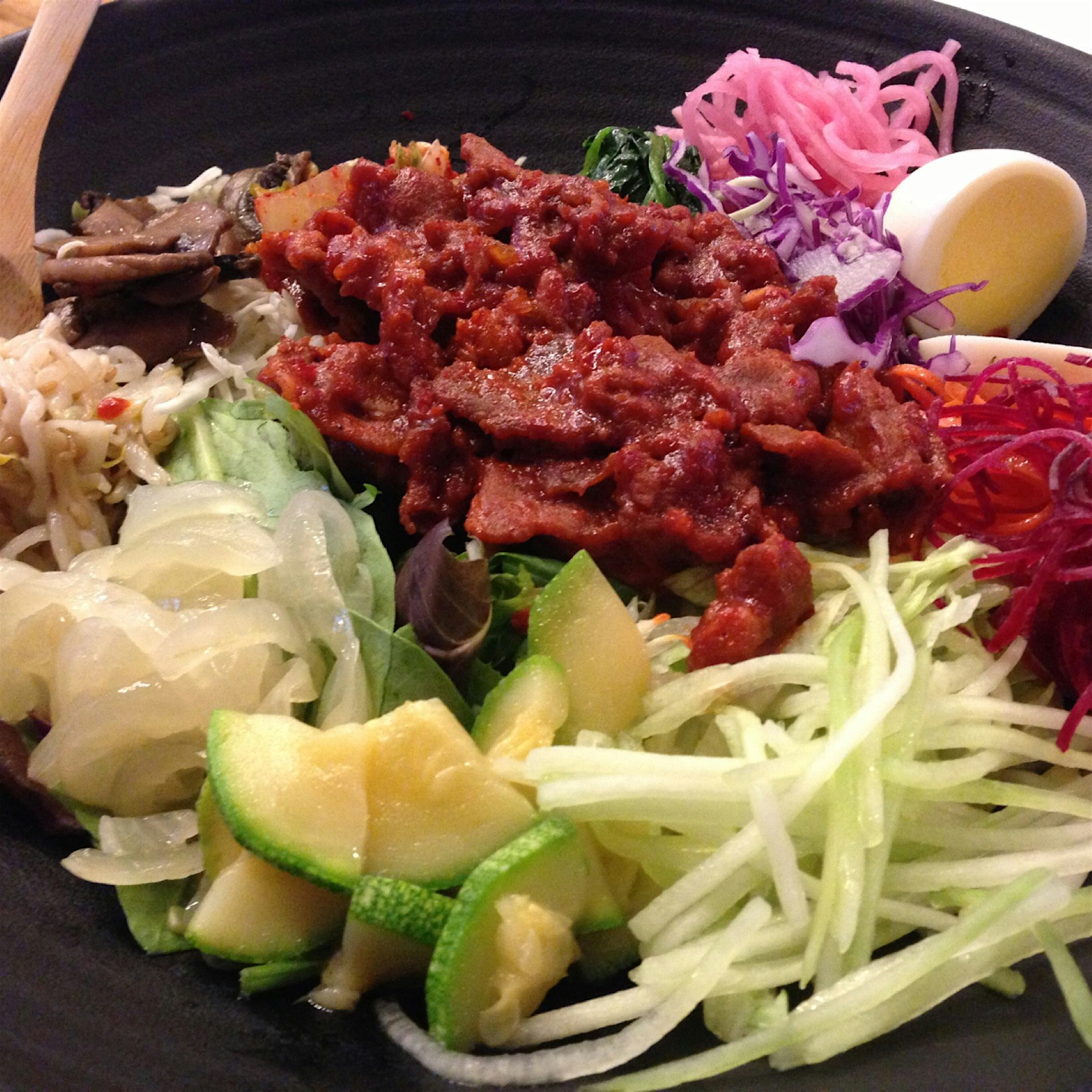 Amazing fresh take on bibimbap from En Hakkore. 16 fresh-cut vegetables. Kimchi. Spicy pork. Smal...