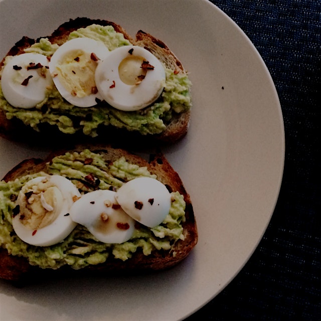 Pan-toasted bread with mashed avocado and a hard-boiled egg, drizzled with Bragg's Liquid Aminos ...