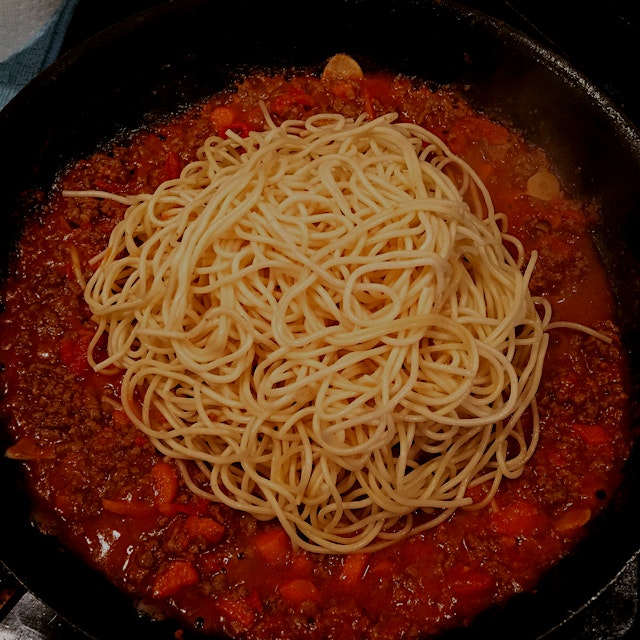 Cook your pasta to "al dente," remove from boiling water and throw directly into sauce. Keep sauc...