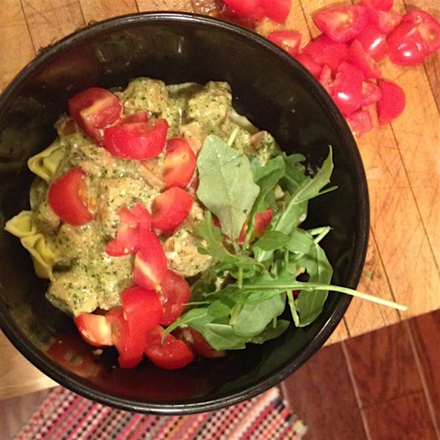 Homemade pesto on spinach ravioli, topped with tomatoes and arugula. (Shed some leaves for the pi...
