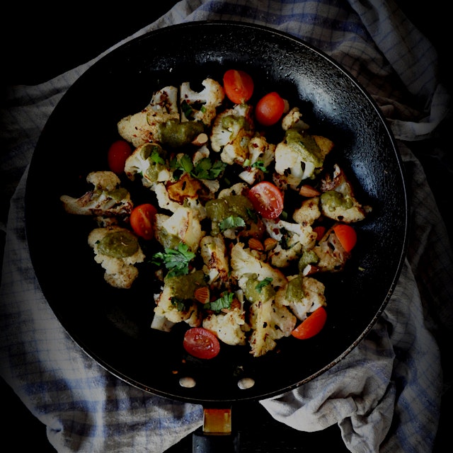 A simple charred cauliflower salad tonight with a drizzle of leftover spinach korma sauce , cherr...
