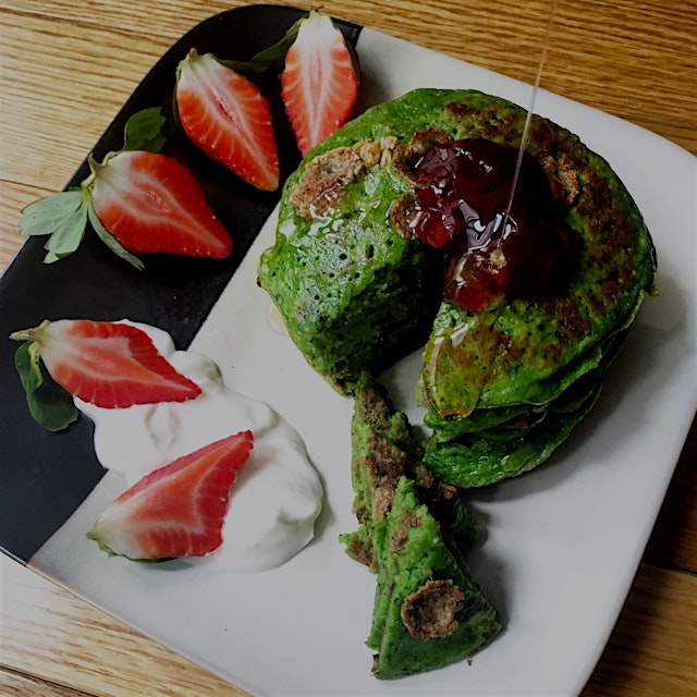 Spinach and matcha green pancakes topped with Crofter's raspberry jam and Wholefoods organic hone...