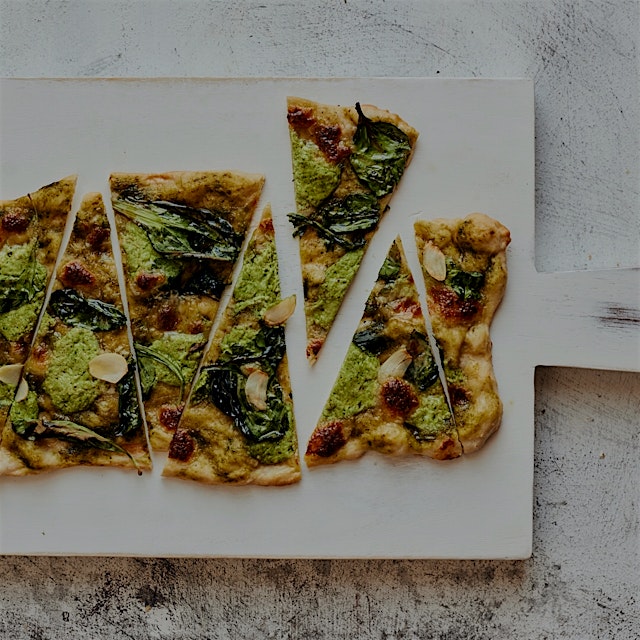 Greens pesto pizza with a healthy dose of garlic on a delightfully thin and crispy crust. #Flavor...