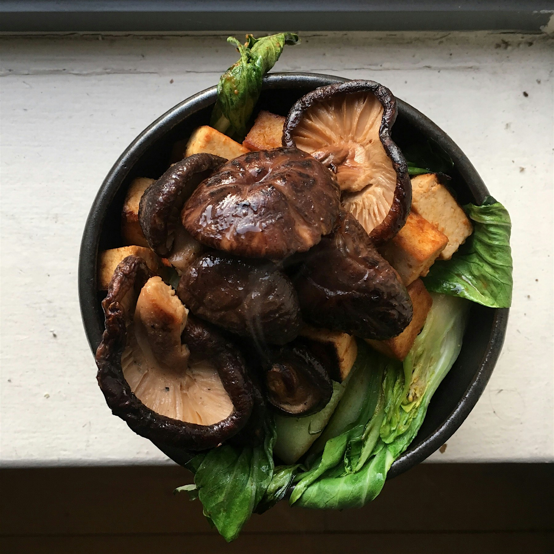 Treating myself to a noodle bowl (they're under there) with tofu, bok choy, and shiitakes 😊