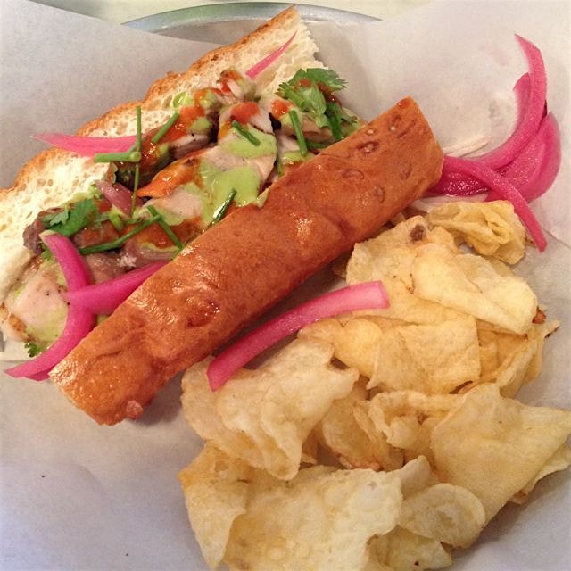 Seared South Carolina Mahi New England-style on a split top buttered roll with pickled onions and...