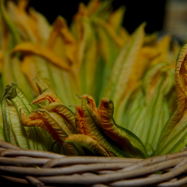 You'll see some zucchini blossoms at the farmers market. Quick-fry them and stuff 'em with ricott...
