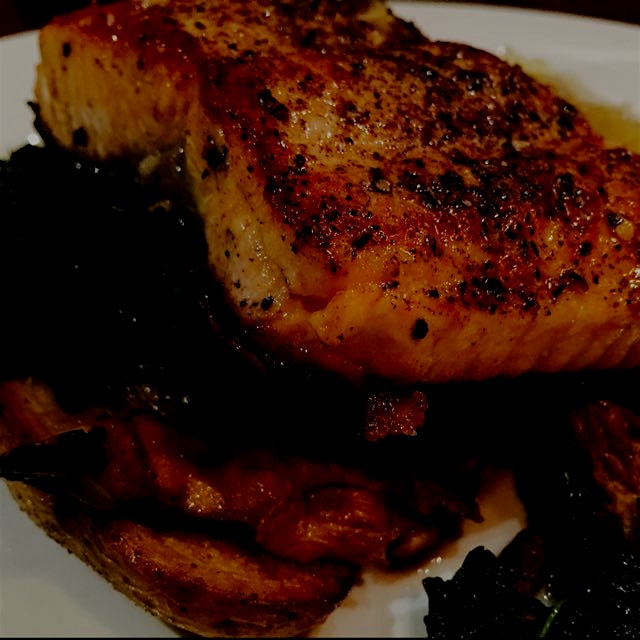 Pepper crusted salmon with braised kale and mushrooms. A new fave restaurant in Brookline! With @...