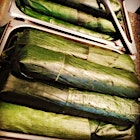 Sticky rice cooked in coconut milk, rolled up in banana leaves = Lemang for 400! Each roll is about a foot long. 20 mins in the oven & done.