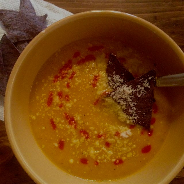 Lunch is served: roasted carrot, apple, & ginger soup. Touch of curry, topped with sriracha and s...