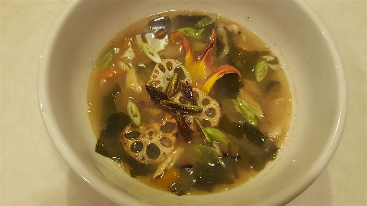 Broth from the duck we smoked with miso, mirin, ginger, garlic, bamboo, bonito flakes, shredded c...