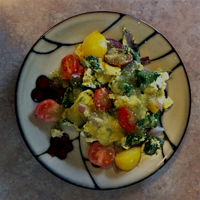 Sautéed red onion, spinach, heirloom tomatoes, and garlic with farm fresh eggs. Topped with some ...