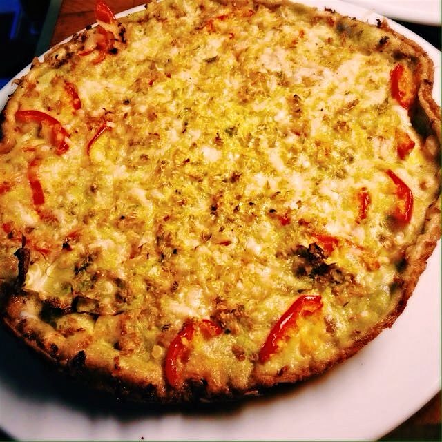 Egg pie with farro,shredded Brussels sprouts, cherry peppers and Parmesan. 