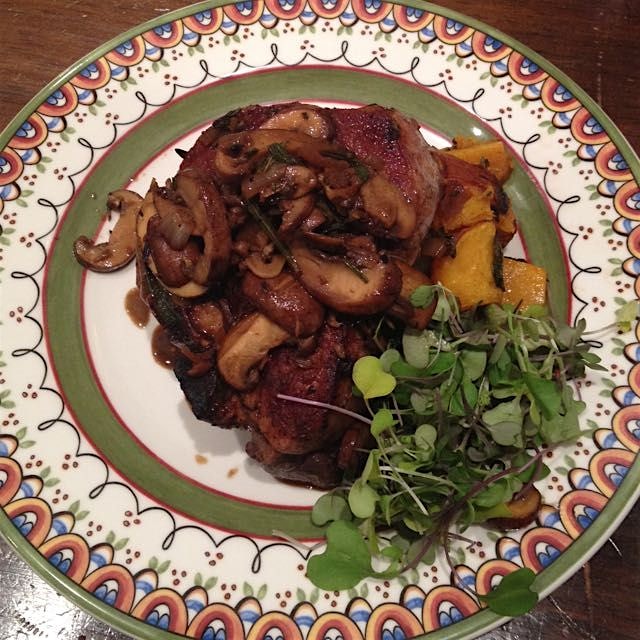 Roasted pork "t-bone" in a Rosemary pan jus with mushrooms over butternut squash and fingerlings ...