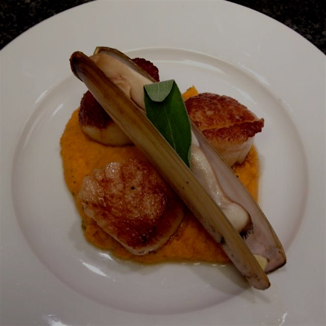Tiger paw scallops and a razor clam over sweet potato and sage purée.