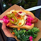 @yeahdawgnyc handmade vegan hot dogs loaded with homemade coconut bacon, pickles, kraut, and kale Caesar salad #veganhotdog #veganshopup