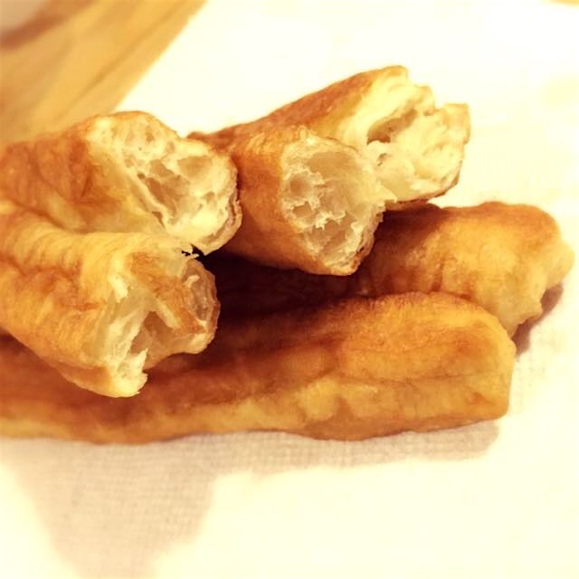 Chinese "yóutiáo" or cruller, or doughnut, or breadstick. In Vietnamese, it's called "quẩy". 
Wha...