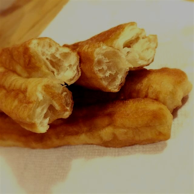 Chinese "yóutiáo" or cruller, or doughnut, or breadstick. In Vietnamese, it's called "quẩy". 
Wha...