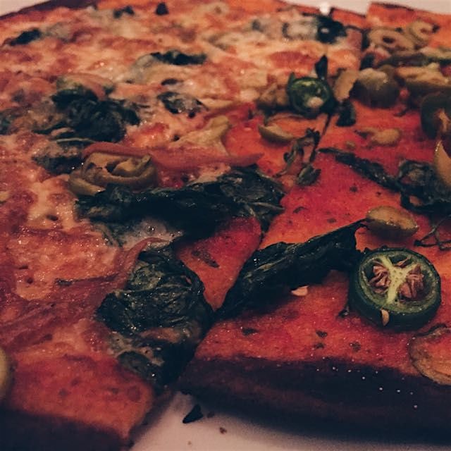 Braised greens, green olives, serrano chiles and smoked mozzarella pie!