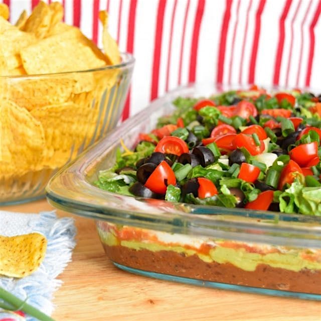 Layered bean dip is our favorite healthy snack for a football party! Go Cowboys! 🏈🎉⭐️Search the l...