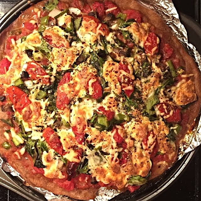 This ain't no dominos. Towering pizza for sports watching. Black bean crust with one bazillion ve...