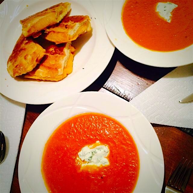 My tomato soup with a dollop of herbed goat cheese crème fraîche and grilled cheddar cheese toast...