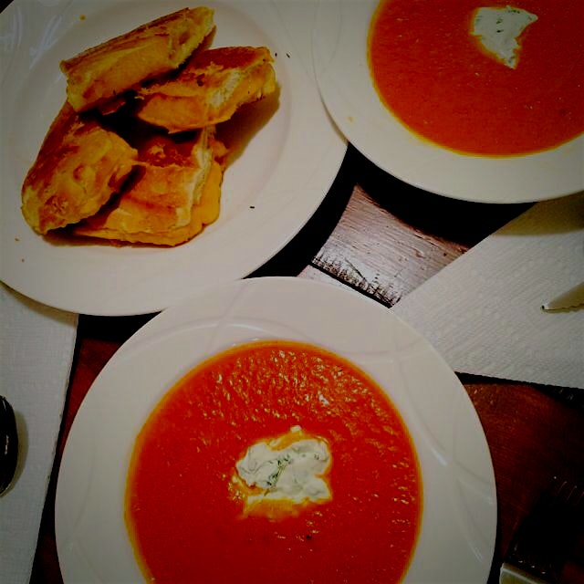 My tomato soup with a dollop of herbed goat cheese crème fraîche and grilled cheddar cheese toast...