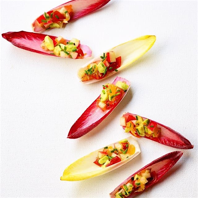 A medley of chopped apples, avocados and tangerines tossed in the champagne vinaigrette atop endi...