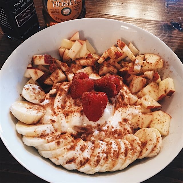 Plain Greek yogurt with sliced apple, banana, raspberries, ground cinnamon and a drizzle of honey