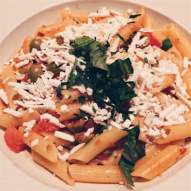 Gluten-free penne with oven-roasted tomatoes, green olives, and ricotta salata