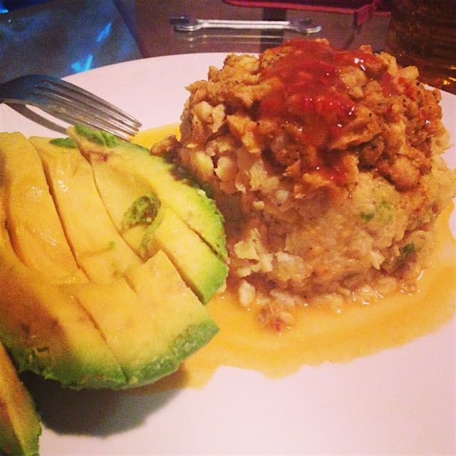 Tilapia stuffed mofongo with pique and a side of avocado. 