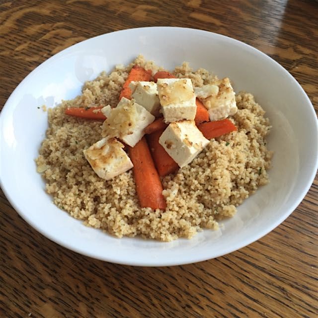 Roasted cumin carrots with leftover tofu atop a bed of whole grain roasted garlic couscous