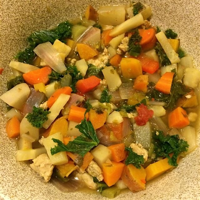 Hearty root vegetable soup with ground turkey, red peppers and kale, all cooked in a sofrito brot...