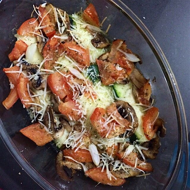 Delicious roasted  zucchinis with grated parmesan cheese, tomatoes, onion, mushroom and oregano d...