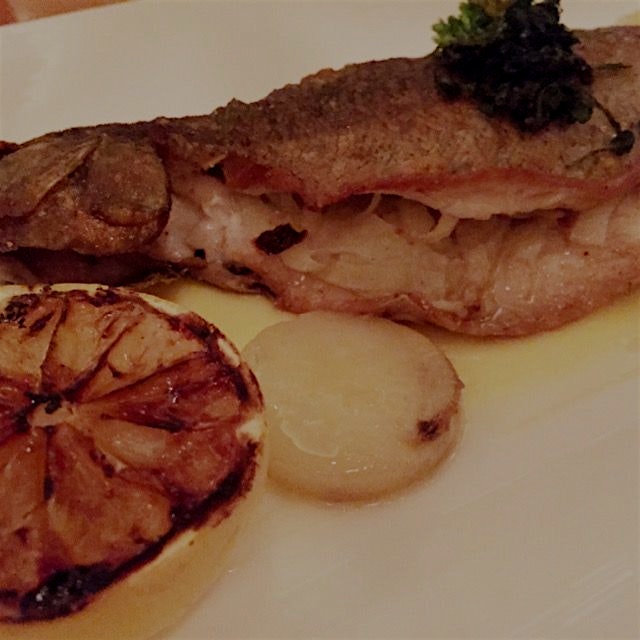 Whole brook trout stuffed with roasted fennel, Yukon gold potatoes and grilled lemon